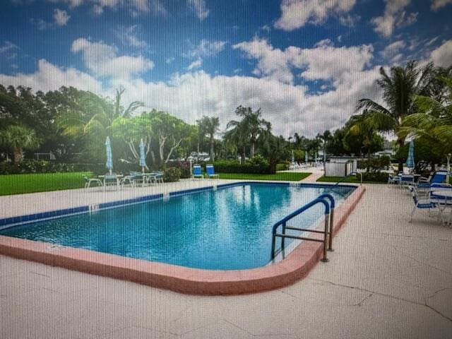 view of swimming pool with a patio