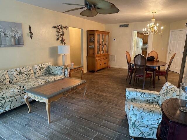 living room featuring ceiling fan with notable chandelier