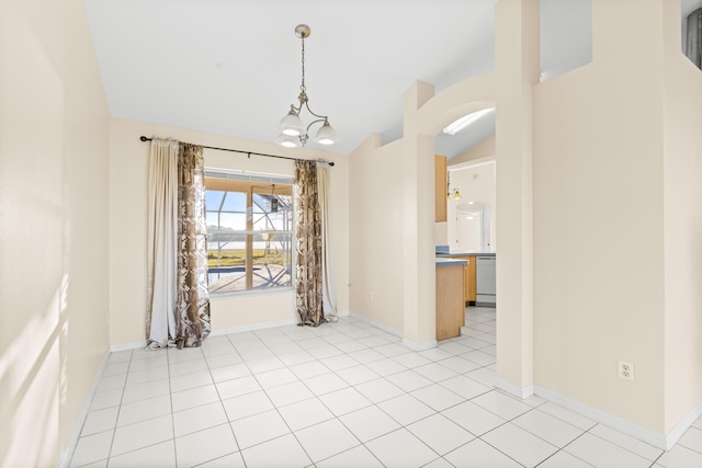 unfurnished dining area featuring lofted ceiling, light tile patterned floors, and a notable chandelier