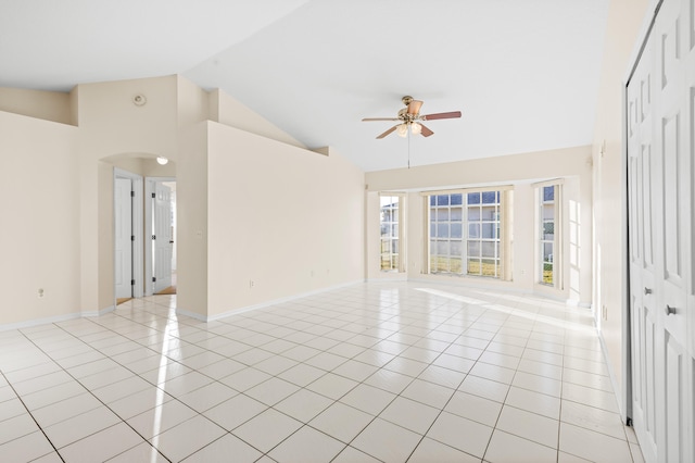 tiled empty room featuring high vaulted ceiling and ceiling fan