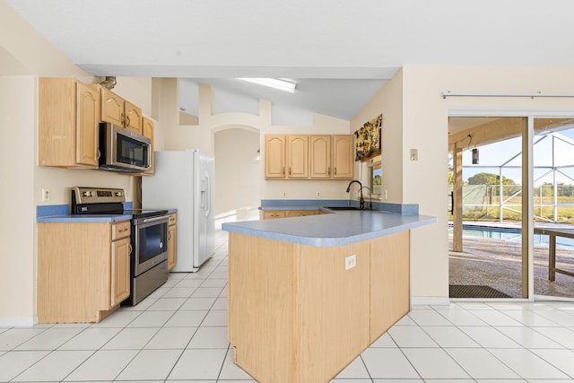 kitchen with appliances with stainless steel finishes, sink, light tile patterned floors, kitchen peninsula, and light brown cabinets