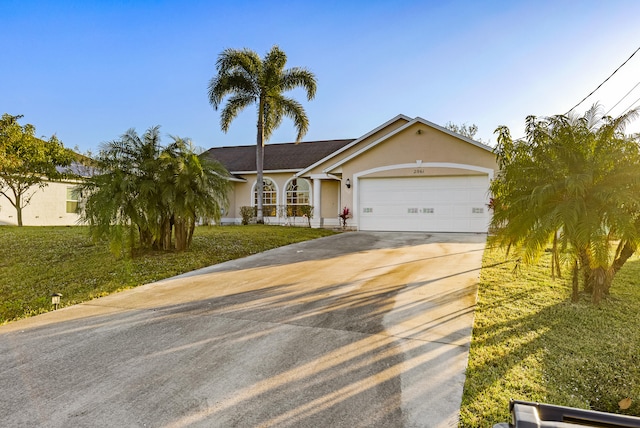 view of front of property featuring a garage and a front yard