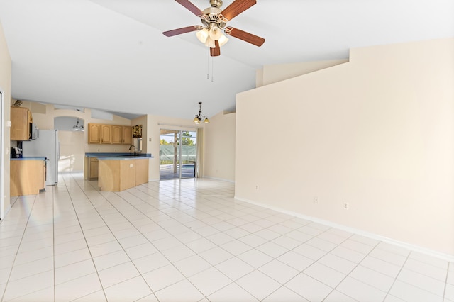 unfurnished living room with light tile patterned floors, ceiling fan with notable chandelier, and high vaulted ceiling