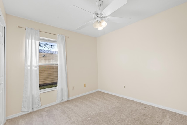 carpeted empty room featuring ceiling fan