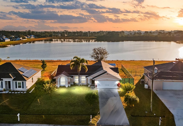 aerial view at dusk with a water view