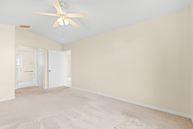 carpeted empty room featuring vaulted ceiling and ceiling fan