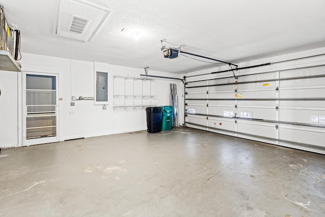 garage with a garage door opener and electric panel