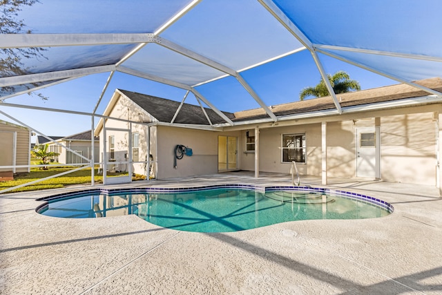 view of swimming pool with a patio and a lanai