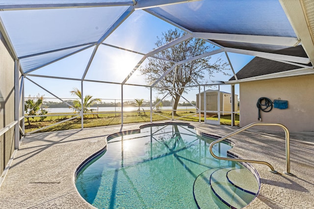 view of swimming pool featuring a storage shed, a lanai, and a patio