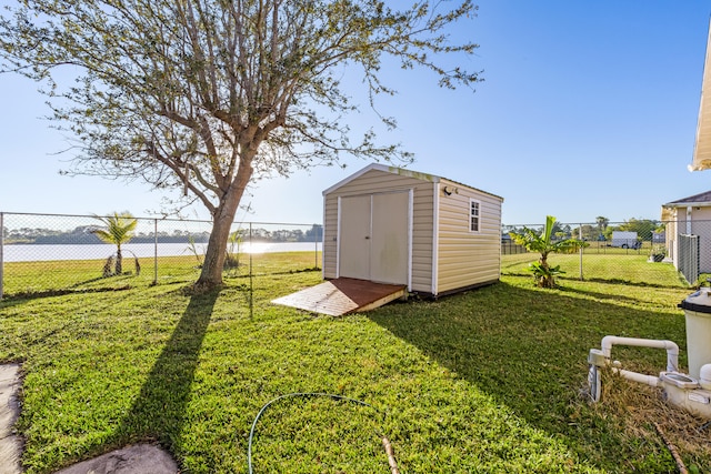 view of yard with a water view and a storage unit