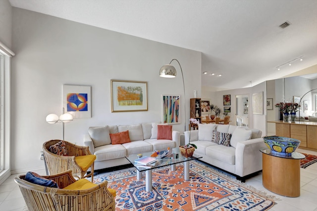 living room featuring rail lighting and light tile patterned floors