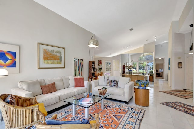 living room featuring light tile patterned floors and high vaulted ceiling