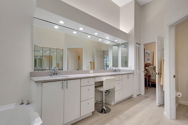 bathroom featuring a tub to relax in, vanity, and hardwood / wood-style floors