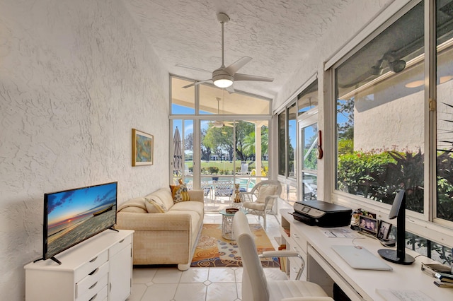 sunroom / solarium with lofted ceiling and ceiling fan