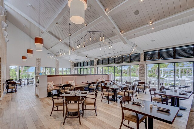 bar featuring french doors, high vaulted ceiling, light hardwood / wood-style flooring, wooden ceiling, and beamed ceiling