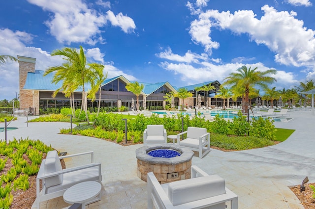 view of patio featuring a community pool and a fire pit