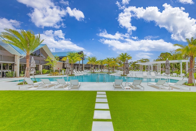 view of swimming pool featuring a patio, a pergola, and a lawn