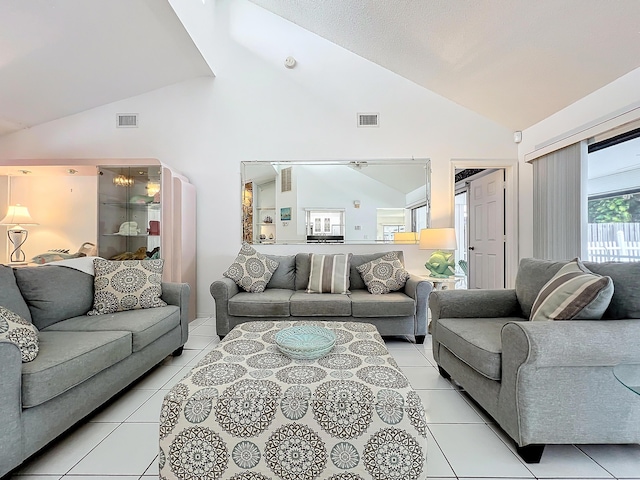 living room with lofted ceiling and light tile patterned flooring