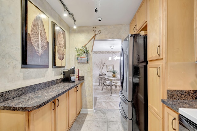 kitchen featuring stainless steel fridge, rail lighting, and light brown cabinets