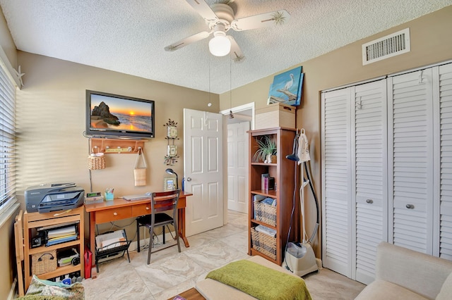 office area featuring ceiling fan and a textured ceiling