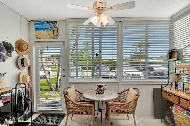 sunroom featuring ceiling fan