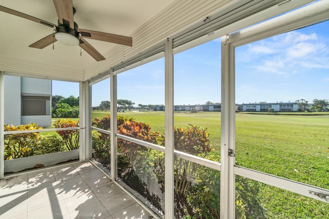 unfurnished sunroom with ceiling fan and a healthy amount of sunlight