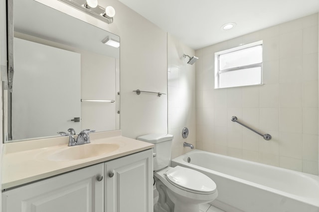 full bathroom with tiled shower / bath, vanity, and toilet