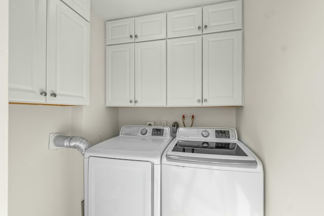 washroom with cabinets and independent washer and dryer