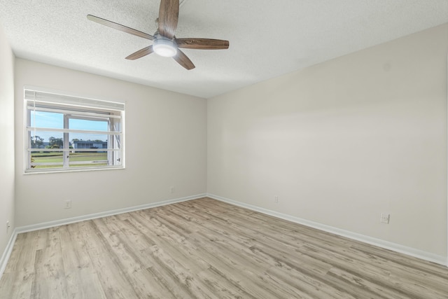 unfurnished room featuring ceiling fan, light hardwood / wood-style floors, and a textured ceiling