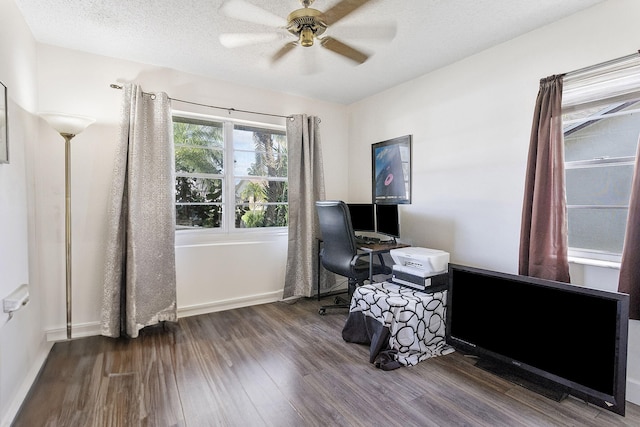 home office featuring ceiling fan, dark hardwood / wood-style floors, and a textured ceiling