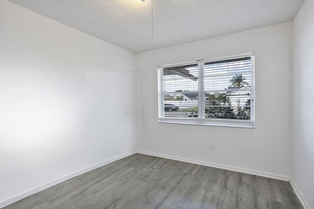 empty room featuring hardwood / wood-style floors and a textured ceiling