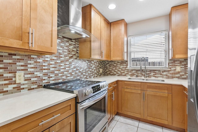 kitchen with sink, light tile patterned floors, backsplash, stainless steel electric stove, and wall chimney exhaust hood