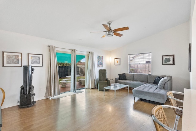 living room with hardwood / wood-style floors, vaulted ceiling, and ceiling fan