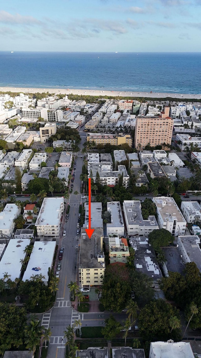 birds eye view of property with a water view and a view of the beach