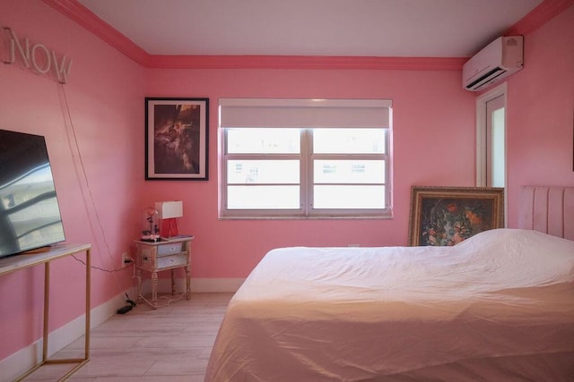 bedroom featuring ornamental molding, light hardwood / wood-style floors, and an AC wall unit