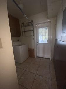 laundry room with dark tile patterned floors