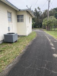 view of side of home with central AC unit