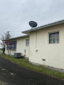 view of side of property with central AC unit