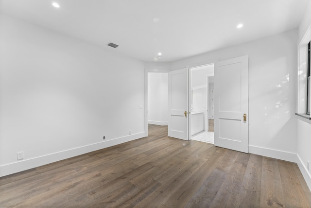 unfurnished bedroom with hardwood / wood-style flooring