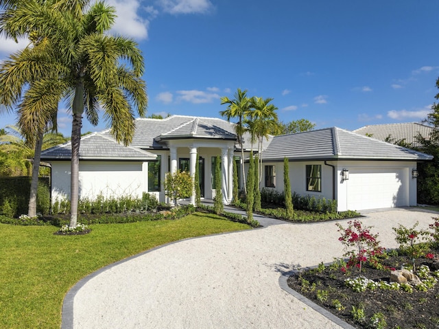 view of front of property with a garage and a front lawn