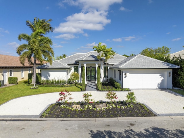 view of front of house with a garage and a front yard