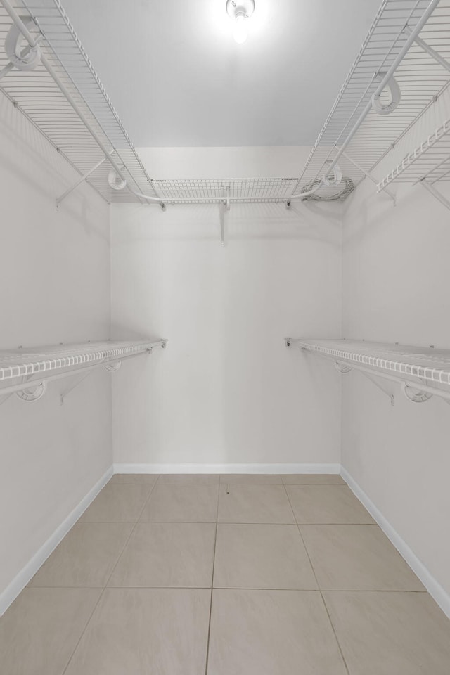 walk in closet featuring tile patterned flooring