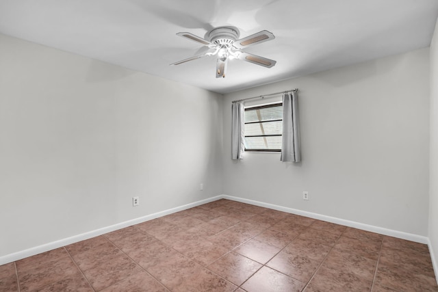 spare room with light tile patterned floors and ceiling fan