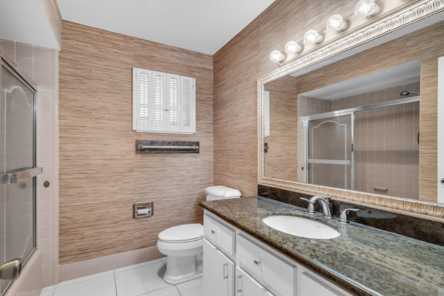 bathroom with tile patterned flooring, vanity, tile walls, and toilet