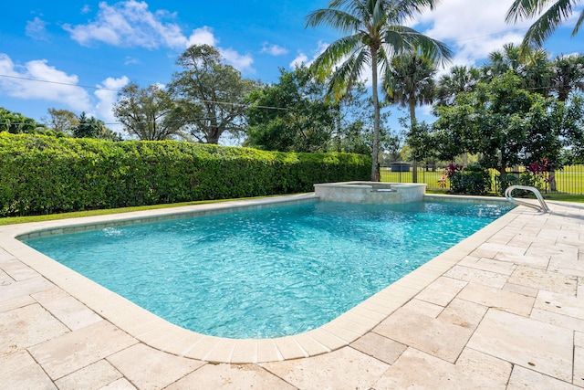 view of swimming pool with an in ground hot tub and a patio