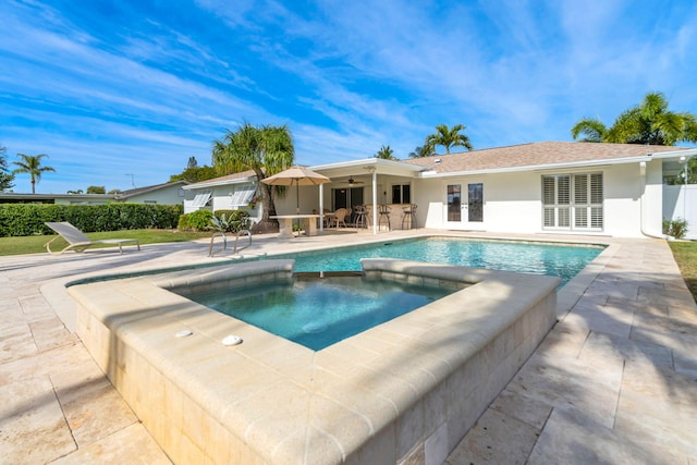 view of swimming pool featuring a patio area, french doors, ceiling fan, and an in ground hot tub