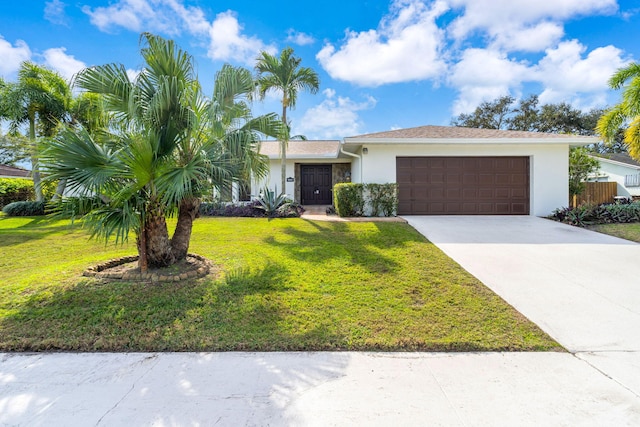 single story home featuring a garage and a front lawn