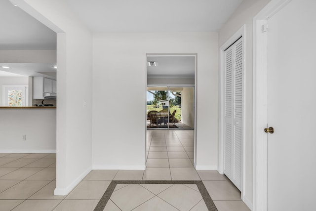 corridor with light tile patterned floors