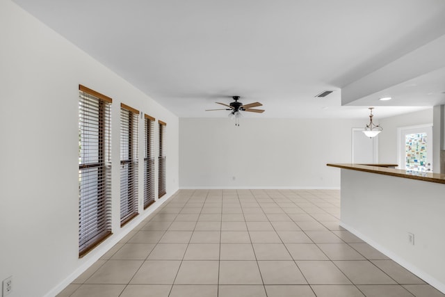 spare room featuring light tile patterned floors and ceiling fan