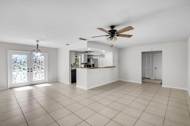 unfurnished living room with light tile patterned flooring, ceiling fan, and french doors